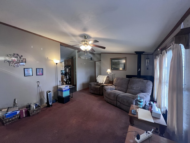 carpeted living room featuring a wood stove, ceiling fan, and ornamental molding