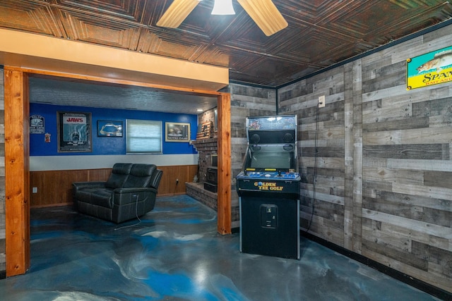 finished basement with a wainscoted wall, an ornate ceiling, wooden walls, and a fireplace