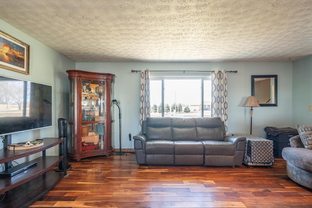 living area with a textured ceiling and wood finished floors