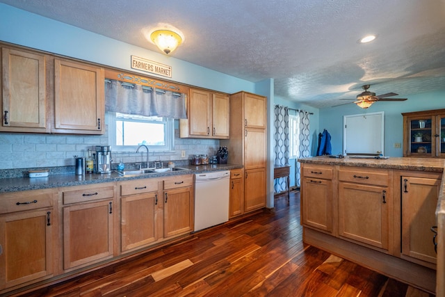 kitchen with a sink, backsplash, a textured ceiling, dark wood finished floors, and dishwasher