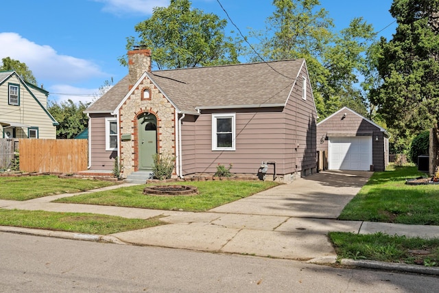 view of front of home featuring an outbuilding, a garage, and a front yard