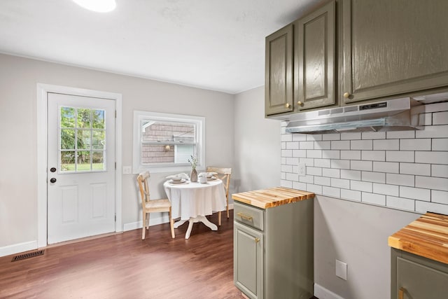 kitchen featuring tasteful backsplash, dark hardwood / wood-style flooring, and butcher block countertops