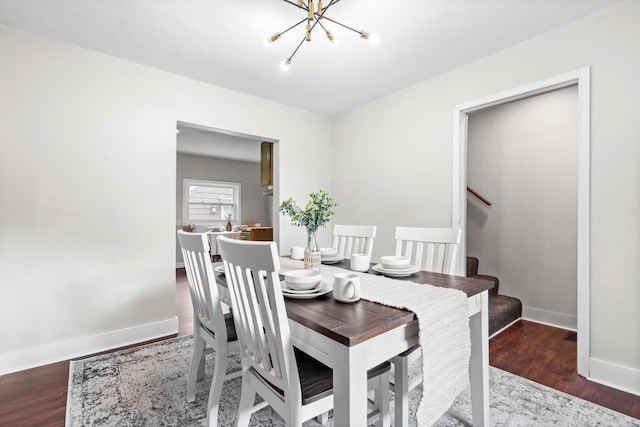 dining room with wood-type flooring and a chandelier