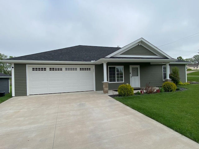200 Malone Ave, Bellefontaine, OH 43311 - single story home featuring concrete driveway, a front yard, an attached garage, a shingled roof, and covered porch