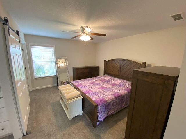 200 Malone Ave, Bellefontaine, OH 43311 - bedroom featuring dark colored carpet, a barn door, baseboards, and a ceiling fan
