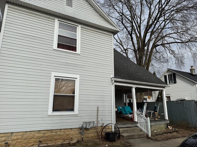 view of side of home with a porch