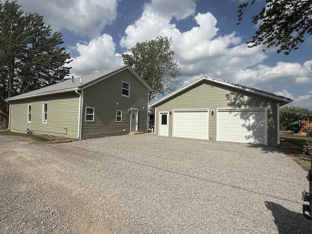 158 E Walnut St, Rockford, OH 45882 - view of property exterior featuring an outbuilding and a detached garage