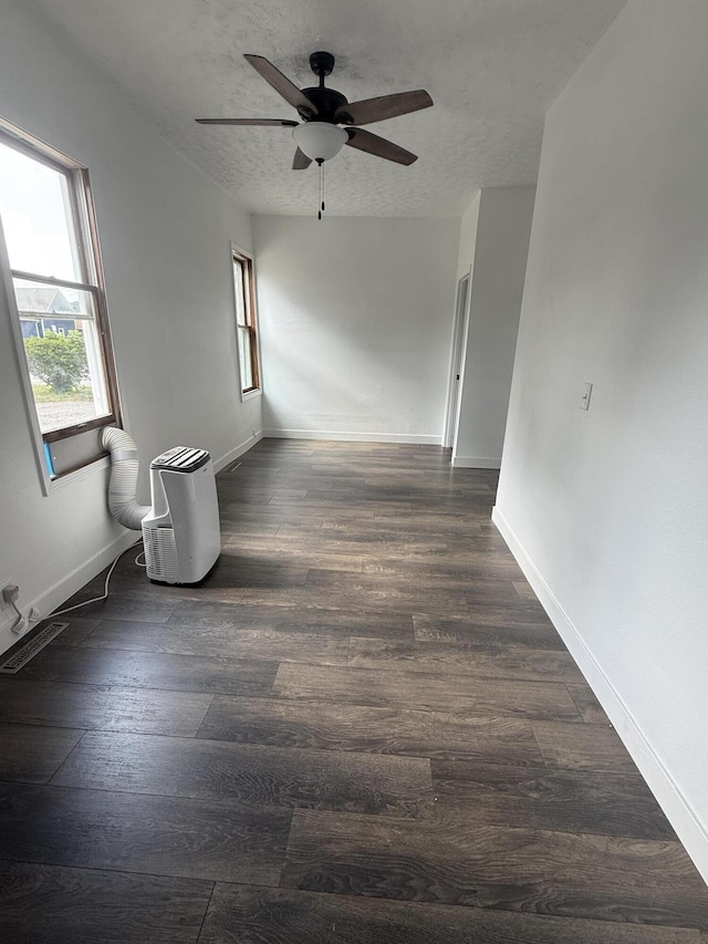 158 E Walnut St, Rockford, OH 45882 - spare room with a ceiling fan, dark wood-type flooring, and a textured ceiling