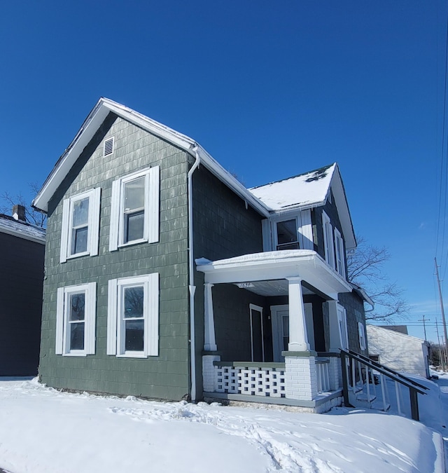 view of snow covered exterior with covered porch