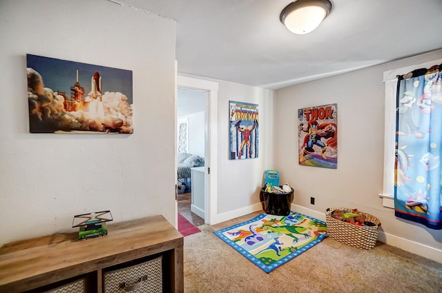 playroom featuring baseboards and carpet flooring