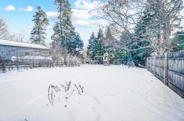 yard covered in snow with fence