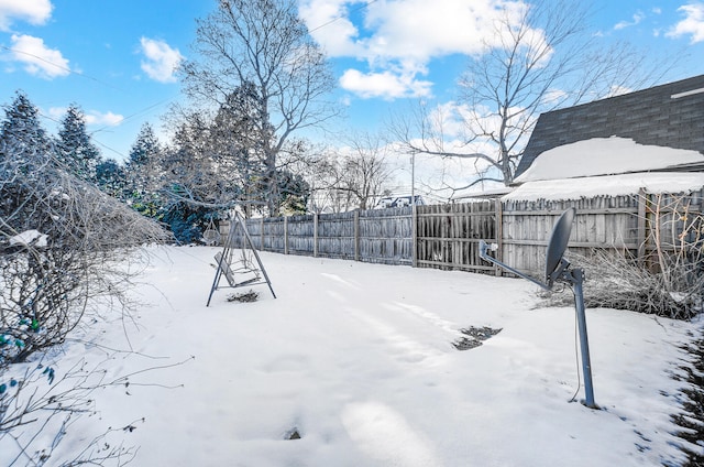 yard layered in snow with fence