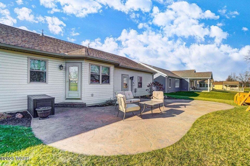 2564 Autumn Ridge Dr, Lima, OH 45804 - rear view of property featuring a patio and a lawn