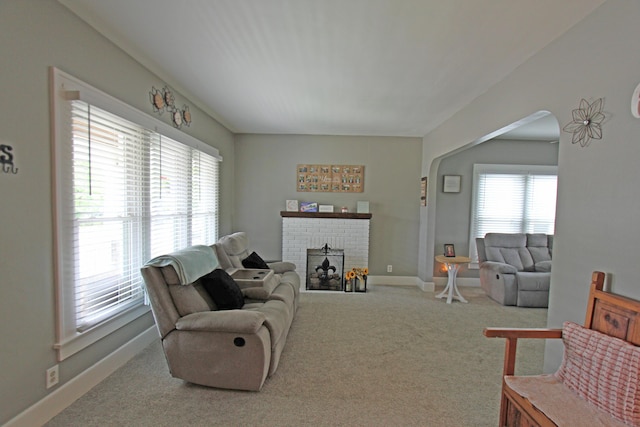 1508 Nicklin Ave, Piqua, OH 45356 - living area with carpet flooring, arched walkways, and a brick fireplace