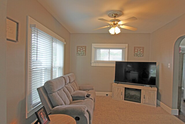 1508 Nicklin Ave, Piqua, OH 45356 - carpeted living room with arched walkways, ceiling fan, and a glass covered fireplace