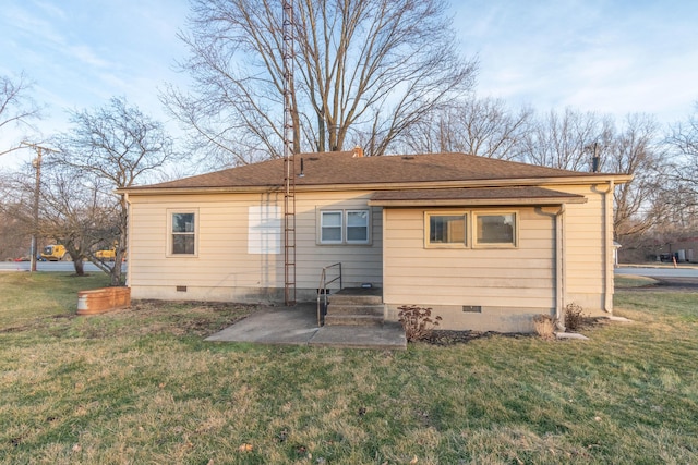 back of house featuring a patio and a yard