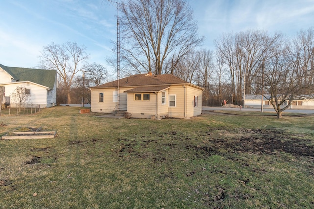 rear view of house with a lawn