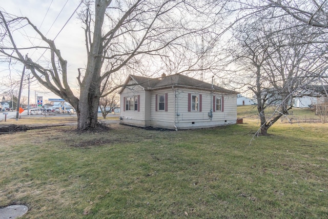 view of side of property with a lawn