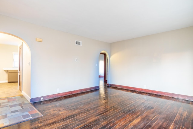 unfurnished room with dark hardwood / wood-style floors