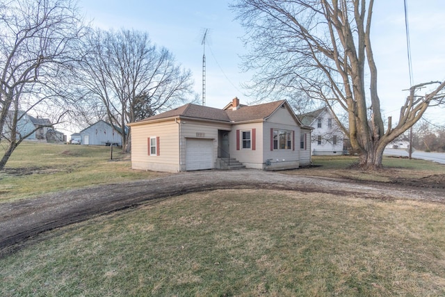 view of front of home featuring a garage and a front lawn