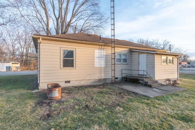 rear view of property featuring a yard