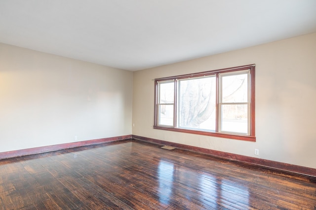 empty room with dark hardwood / wood-style floors