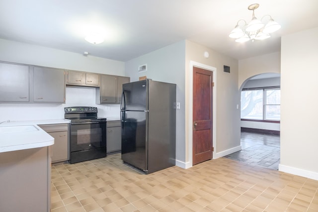 kitchen with sink, gray cabinets, an inviting chandelier, hanging light fixtures, and black appliances