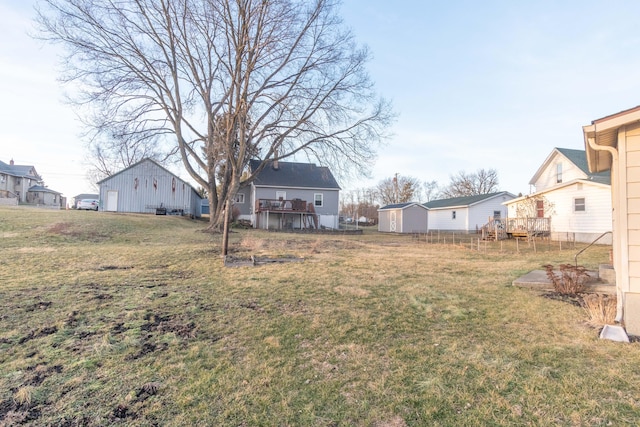 view of yard with an outbuilding and a wooden deck