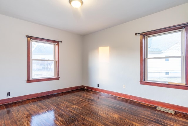 spare room with dark hardwood / wood-style floors