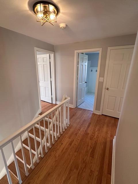 hallway featuring baseboards and wood finished floors