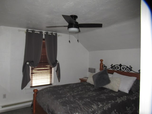 bedroom featuring vaulted ceiling, ceiling fan, and baseboard heating