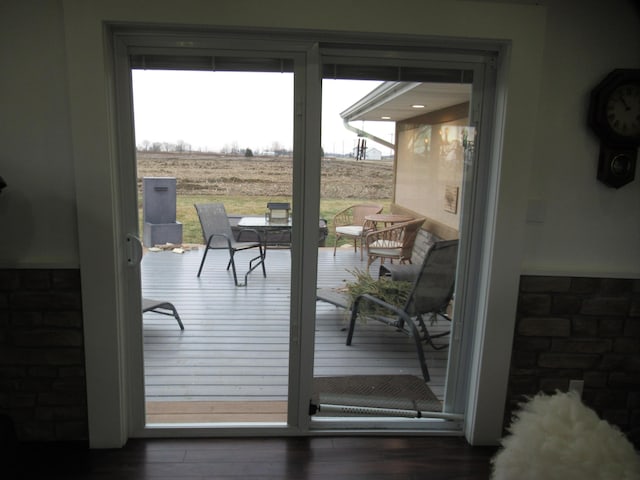 entryway featuring dark hardwood / wood-style flooring and a rural view