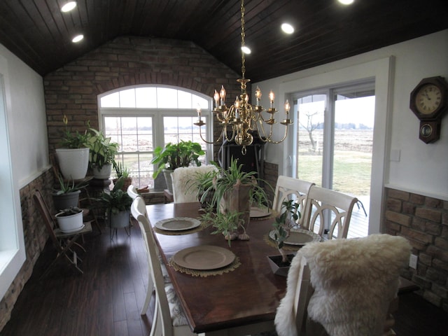 dining space featuring plenty of natural light, dark hardwood / wood-style flooring, a chandelier, and vaulted ceiling