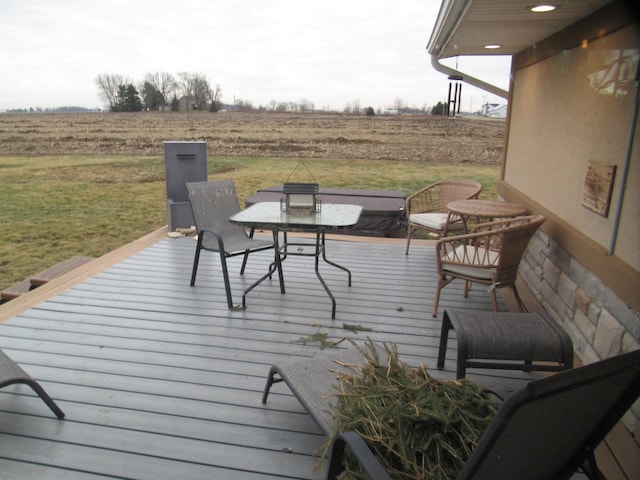 deck featuring a rural view and a lawn