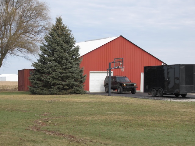 view of outbuilding featuring a yard and a garage