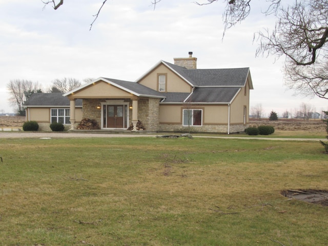 view of front of home with a front yard and french doors