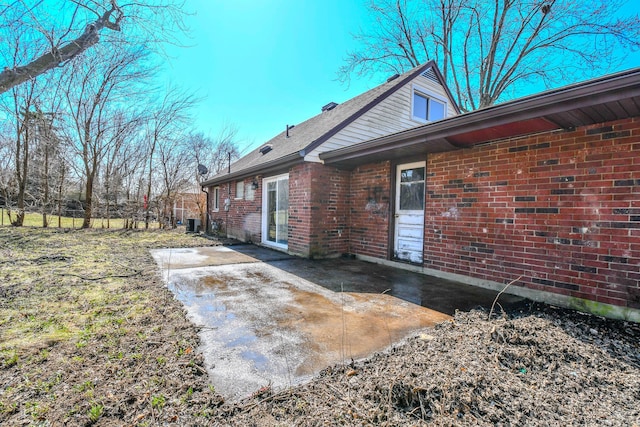 back of house with a patio area and brick siding