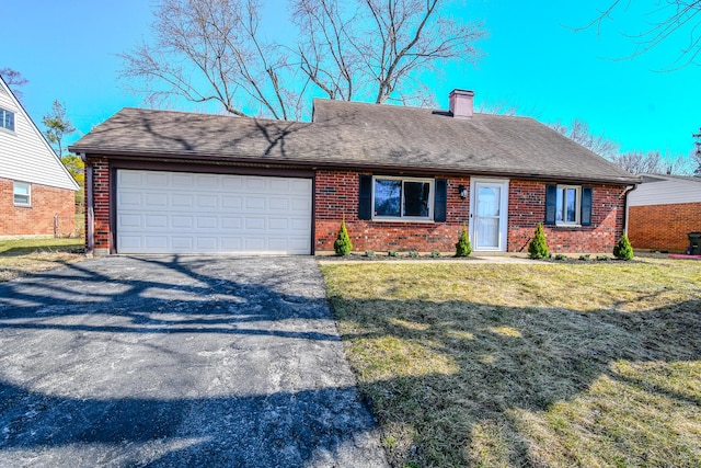 single story home with brick siding, a garage, a front lawn, and driveway