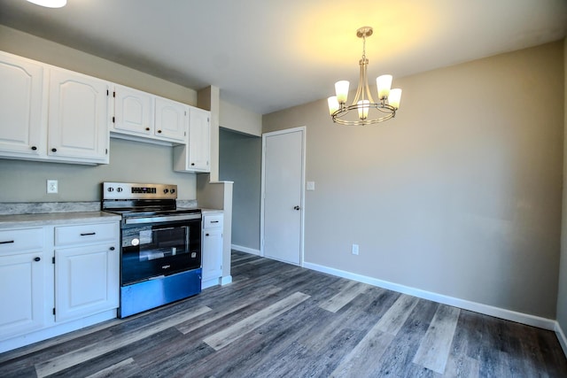 kitchen with electric range, baseboards, a notable chandelier, and white cabinets