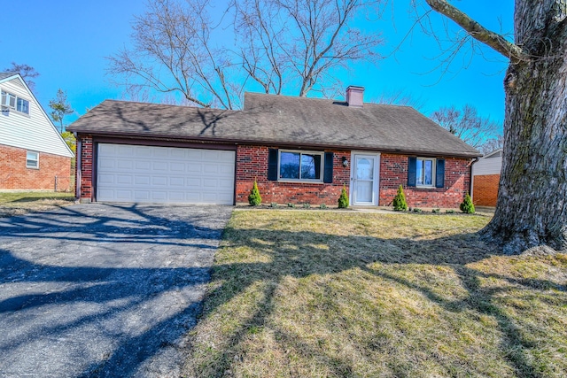 single story home with a front yard, driveway, an attached garage, a chimney, and brick siding