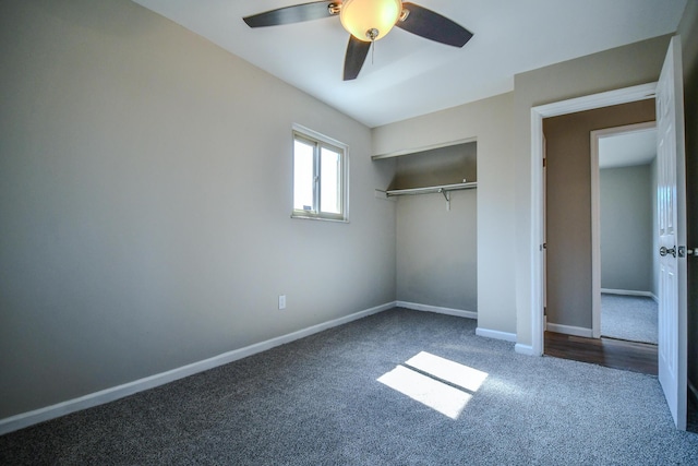 unfurnished bedroom with a closet, a ceiling fan, baseboards, and dark colored carpet