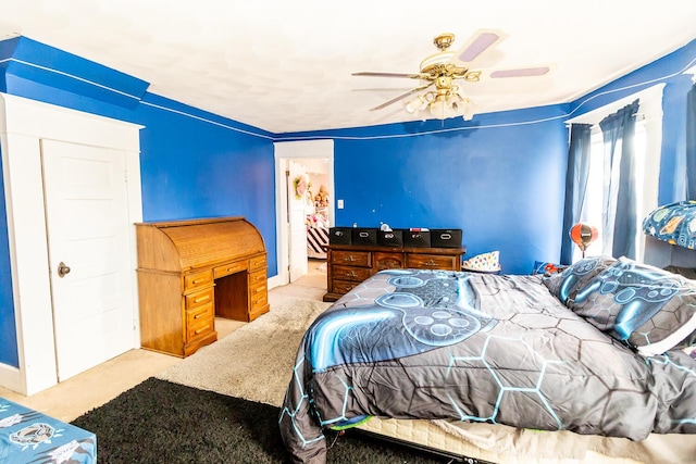 bedroom with a ceiling fan and carpet