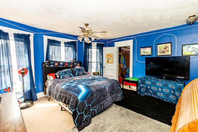 bedroom with a closet, ceiling fan, and carpet