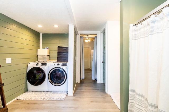 laundry area featuring washing machine and dryer, wooden walls, wood finished floors, ceiling fan, and recessed lighting
