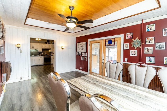 dining space with a ceiling fan, a raised ceiling, wooden ceiling, and dark wood finished floors