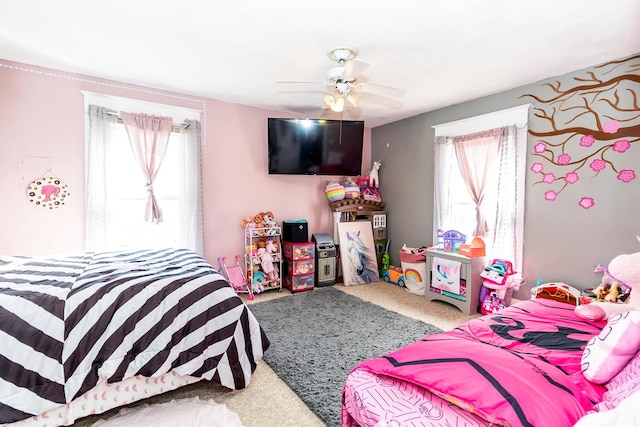 bedroom featuring carpet flooring, multiple windows, and ceiling fan