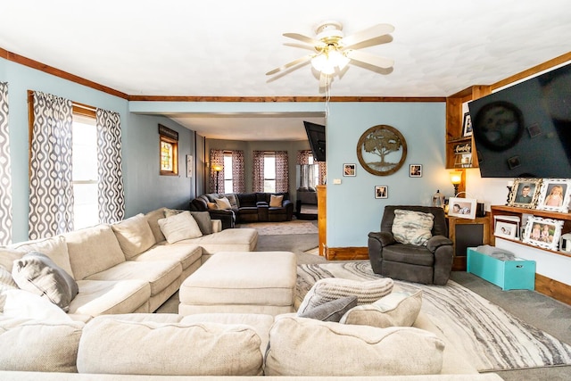 living room with ornamental molding, carpet, a healthy amount of sunlight, and ceiling fan