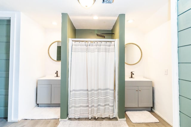 bathroom featuring a sink, a shower with shower curtain, and wood finished floors