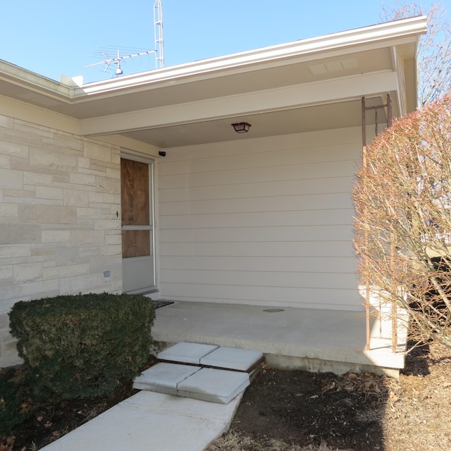 entrance to property with stone siding