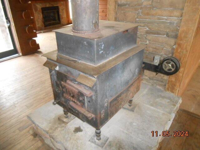 interior details featuring wood finished floors and a fireplace